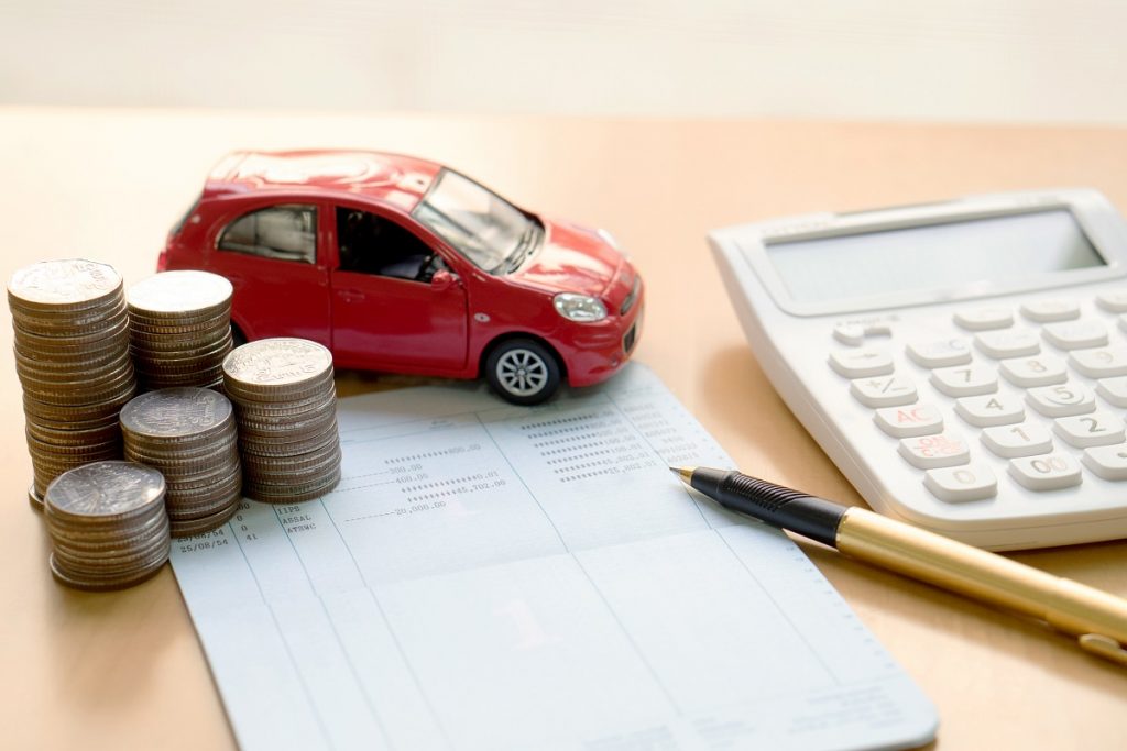 Money, small car model and calculator