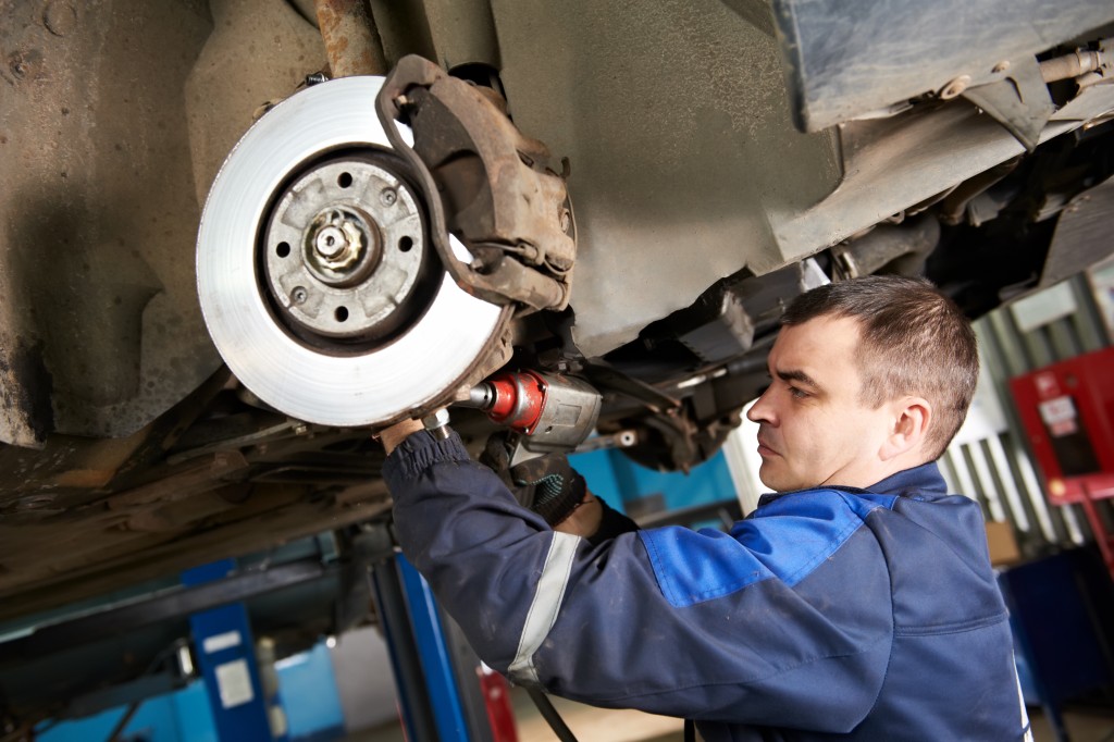 Car mechanic examining a vehicle