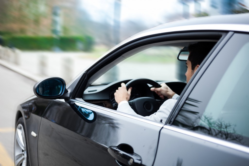 Portrait of a man driving a car