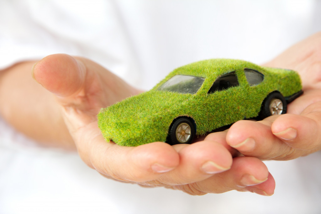 A small car model with grasses growing on it