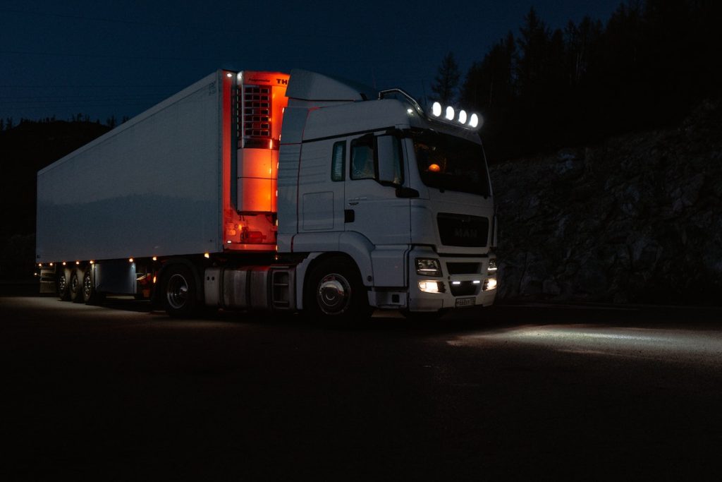 trucks travelling at night with lights on its bottom